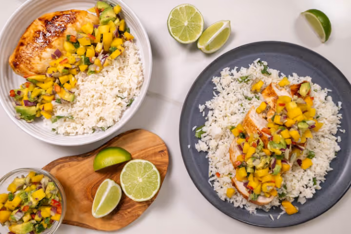 A plate of food with rice and fruitAI-generated content may be incorrect.