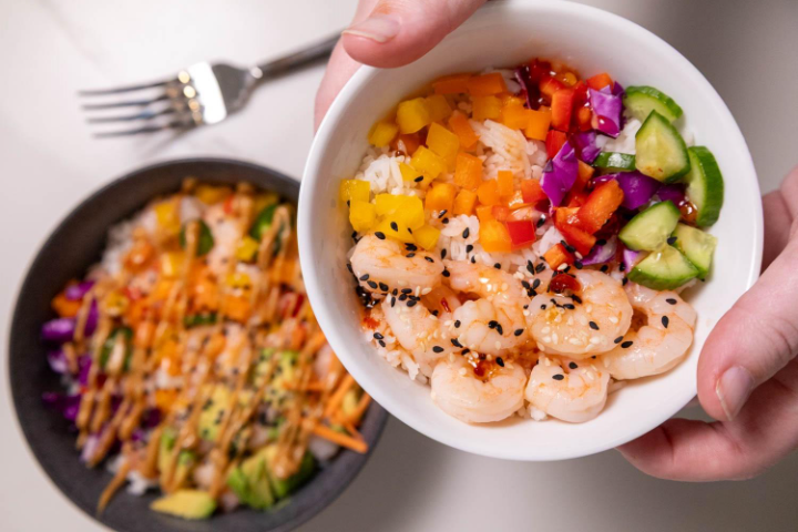 A bowl of food with a fork and a bowl of riceAI-generated content may be incorrect.