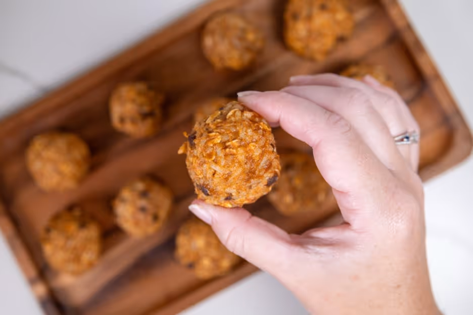 A hand holding a round brown objectAI-generated content may be incorrect.