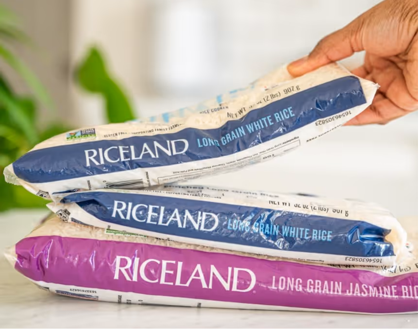 A hand holding a bag of riceAI-generated content may be incorrect.