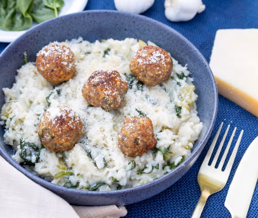 A bowl of rice and meatballsAI-generated content may be incorrect.