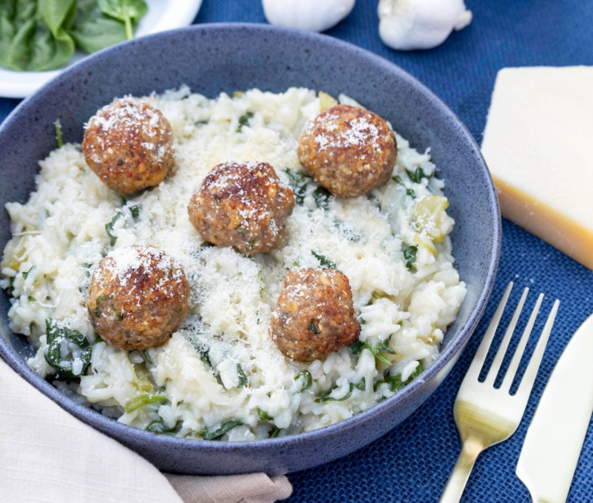 A bowl of rice and meatballsAI-generated content may be incorrect.