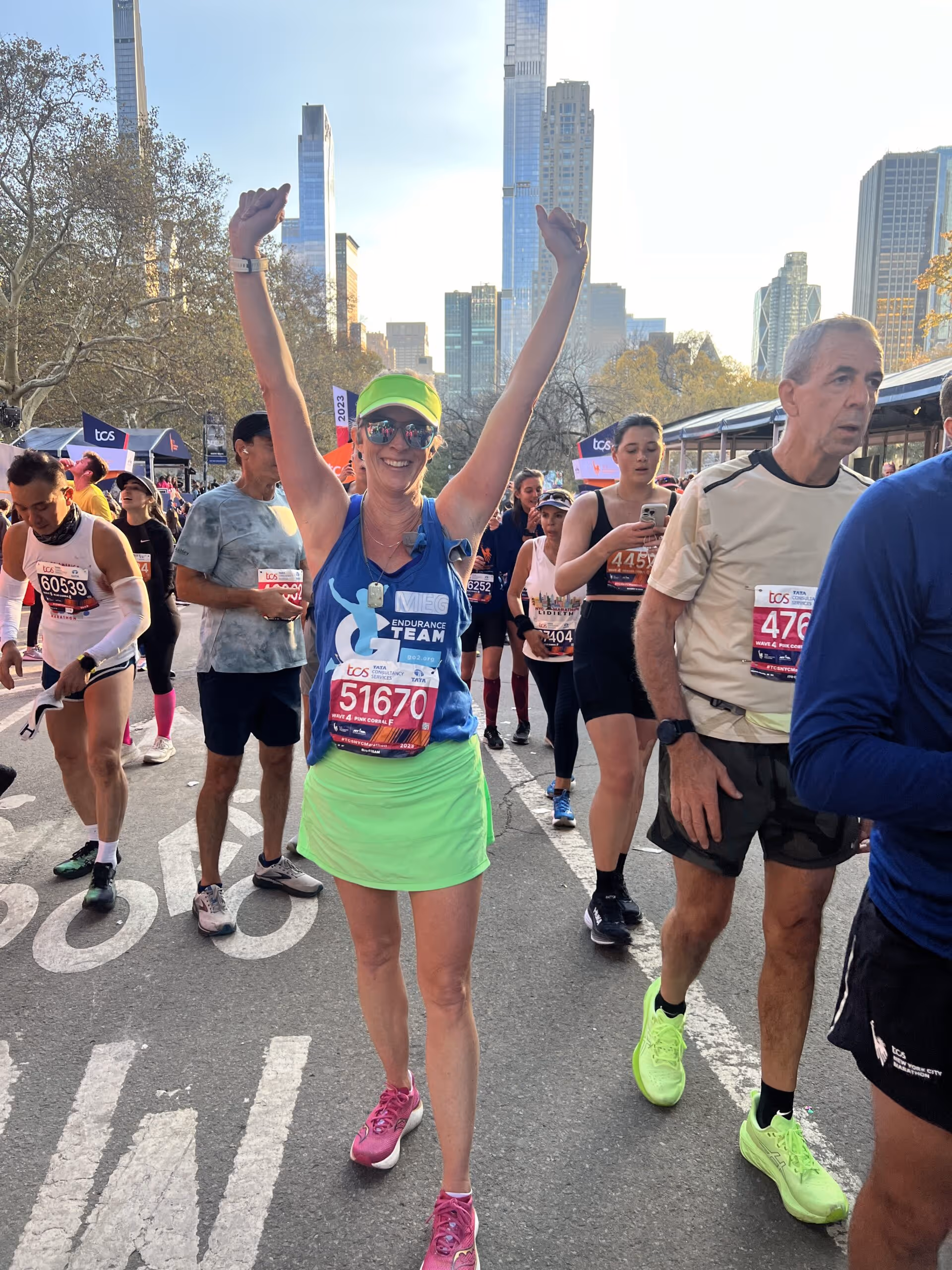 Meg at a race with her arms up