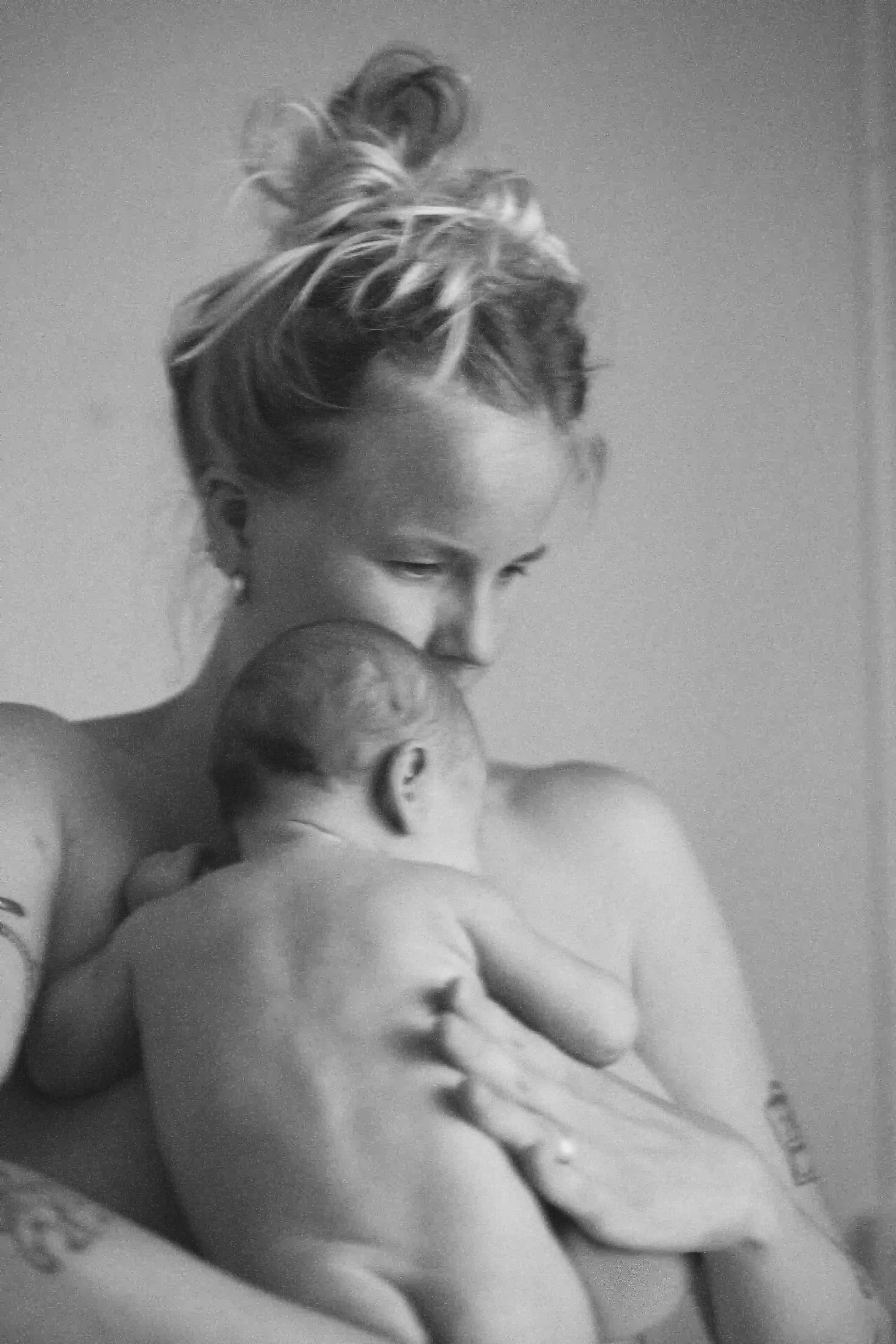 A mother holding her daughter skin to skin 