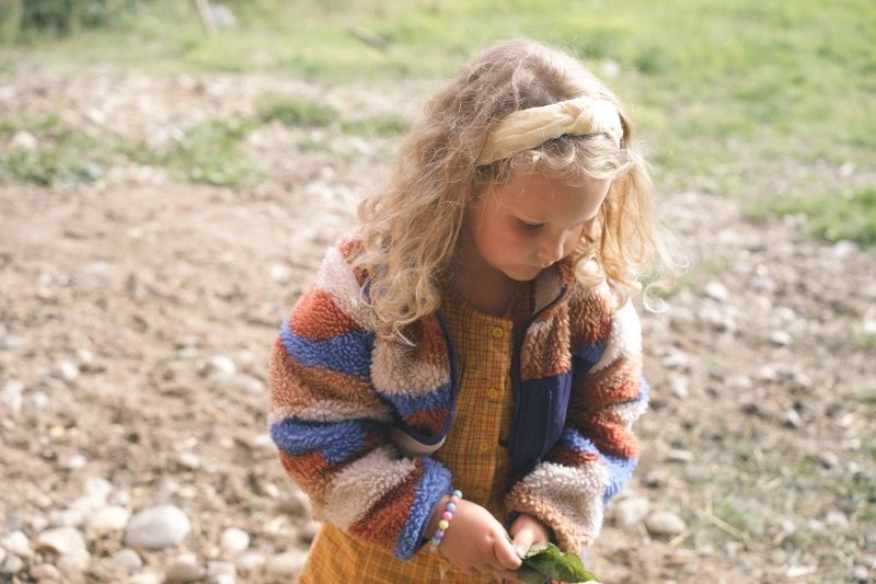 A daughter playing outside during a family photoshoot 