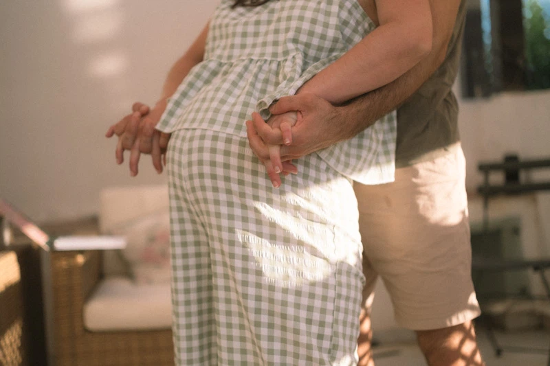 A pregnant women dancing with her husband during a blessing way 