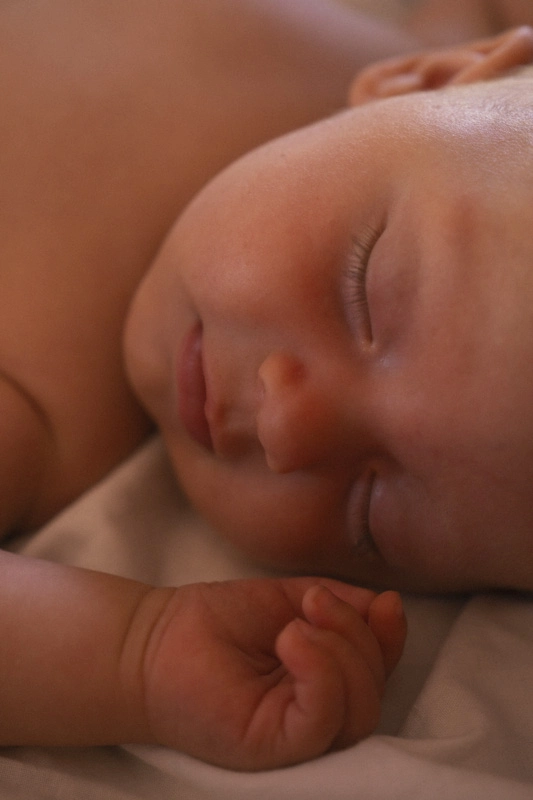 A close up photo of a newborn baby sleeping