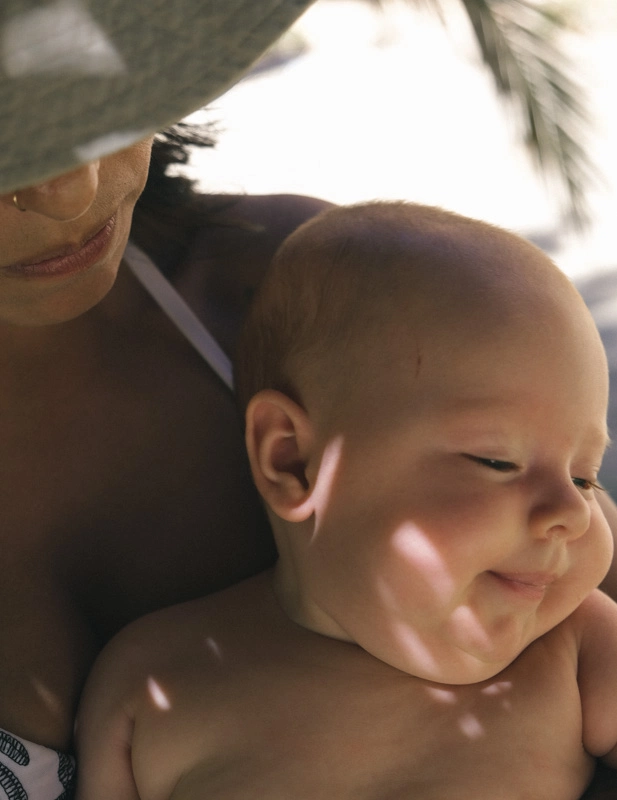 A mother holding her naked baby in 