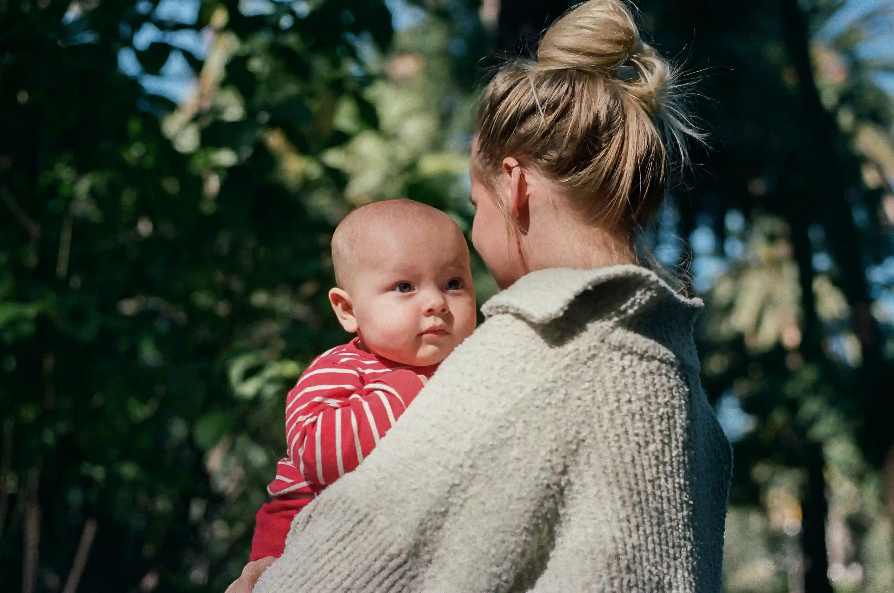 A mom holding her baby in a park in Malaga