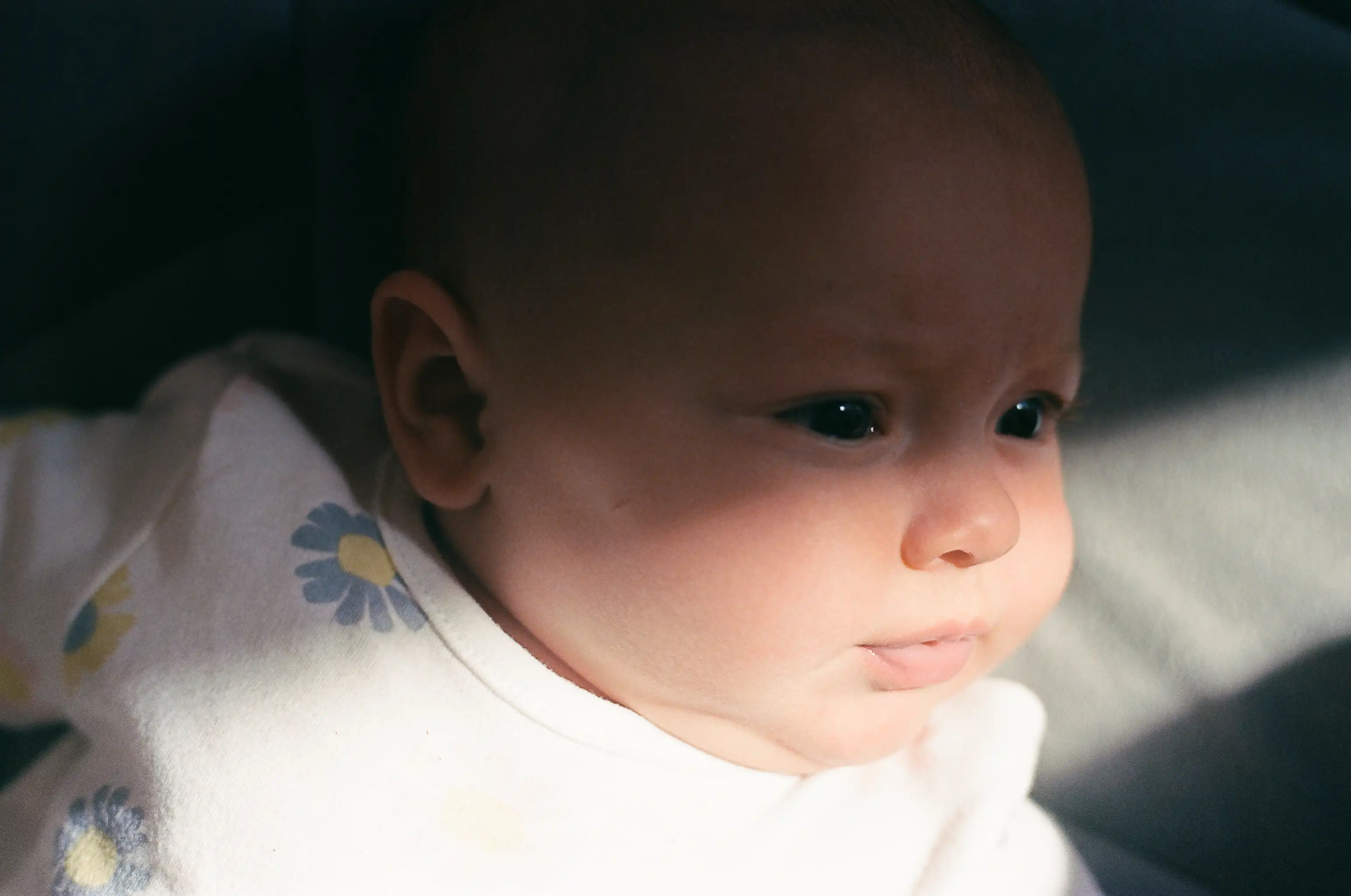 Baby lying on the floor with the sun shining 