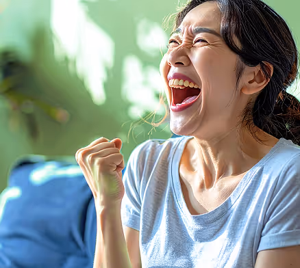 Woman excited and celebrating pumping her fist. 