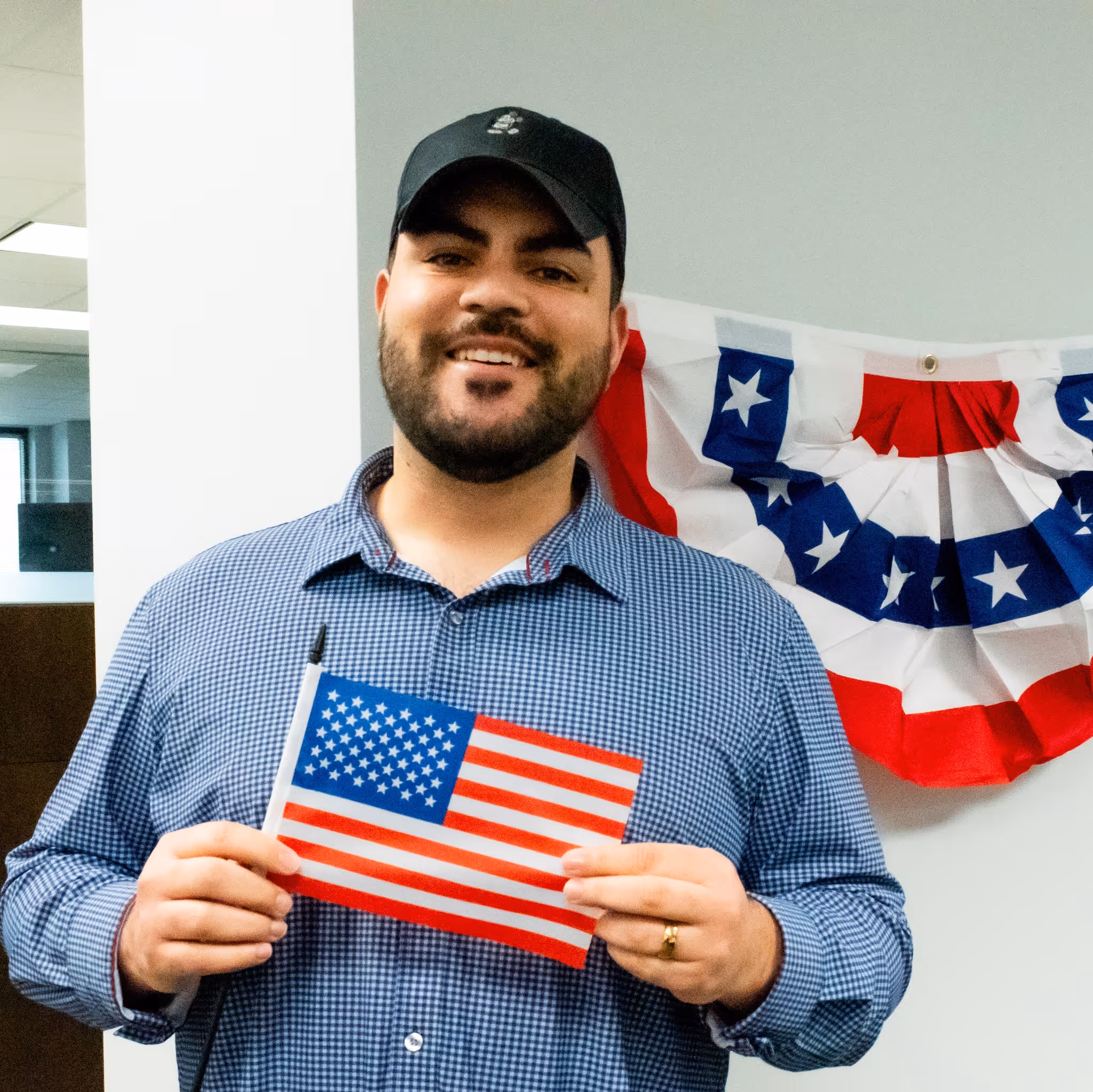 Marvin Gonzalez holding an American flag. 