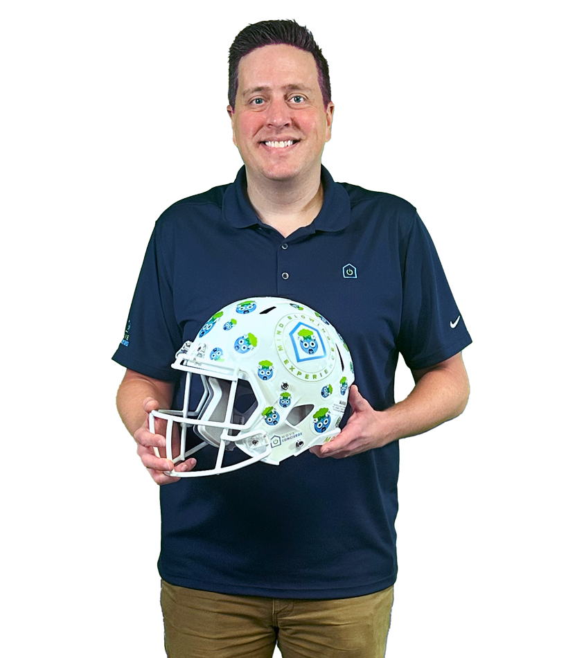 Neil Daniel holding the mind blowing customer experiences core value award. 