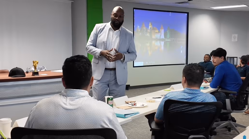 An instructor coaching a training class of new concierges. 