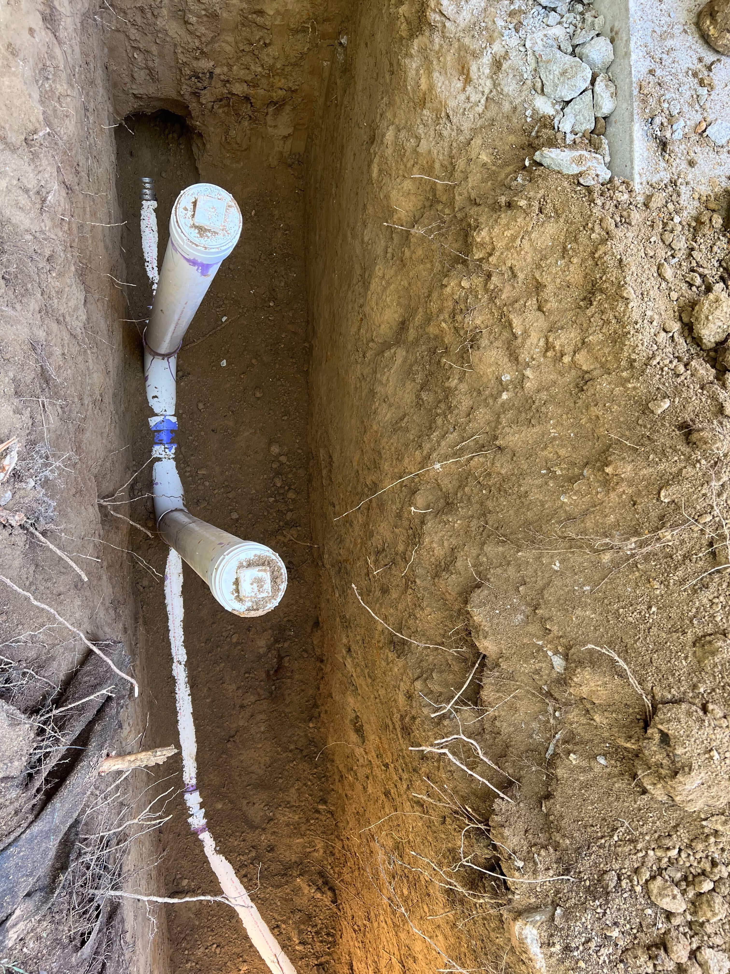 Interior sewer trench exposing old piping