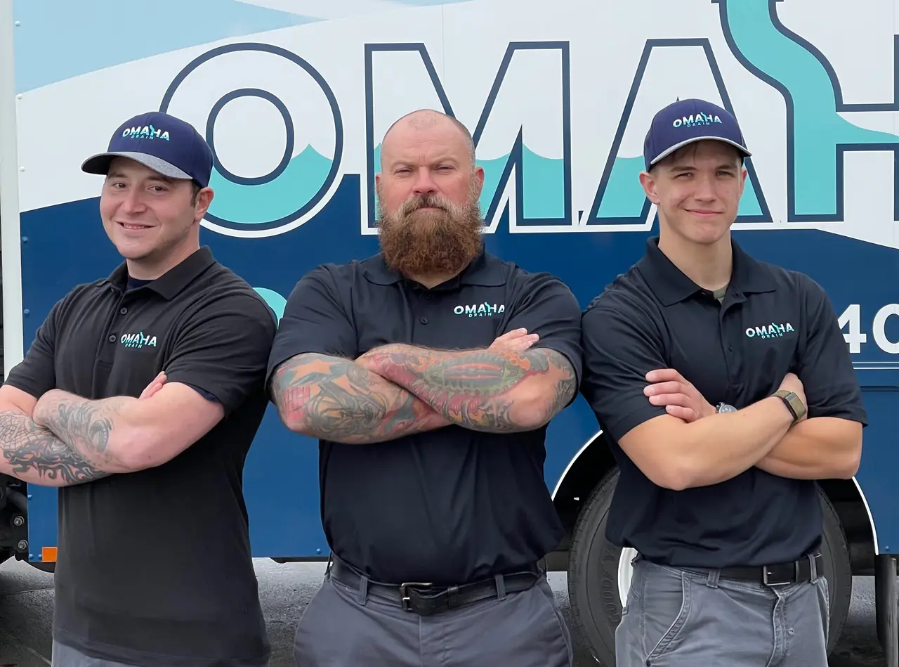The Omaha Drain team in front of a wrapped service truck
