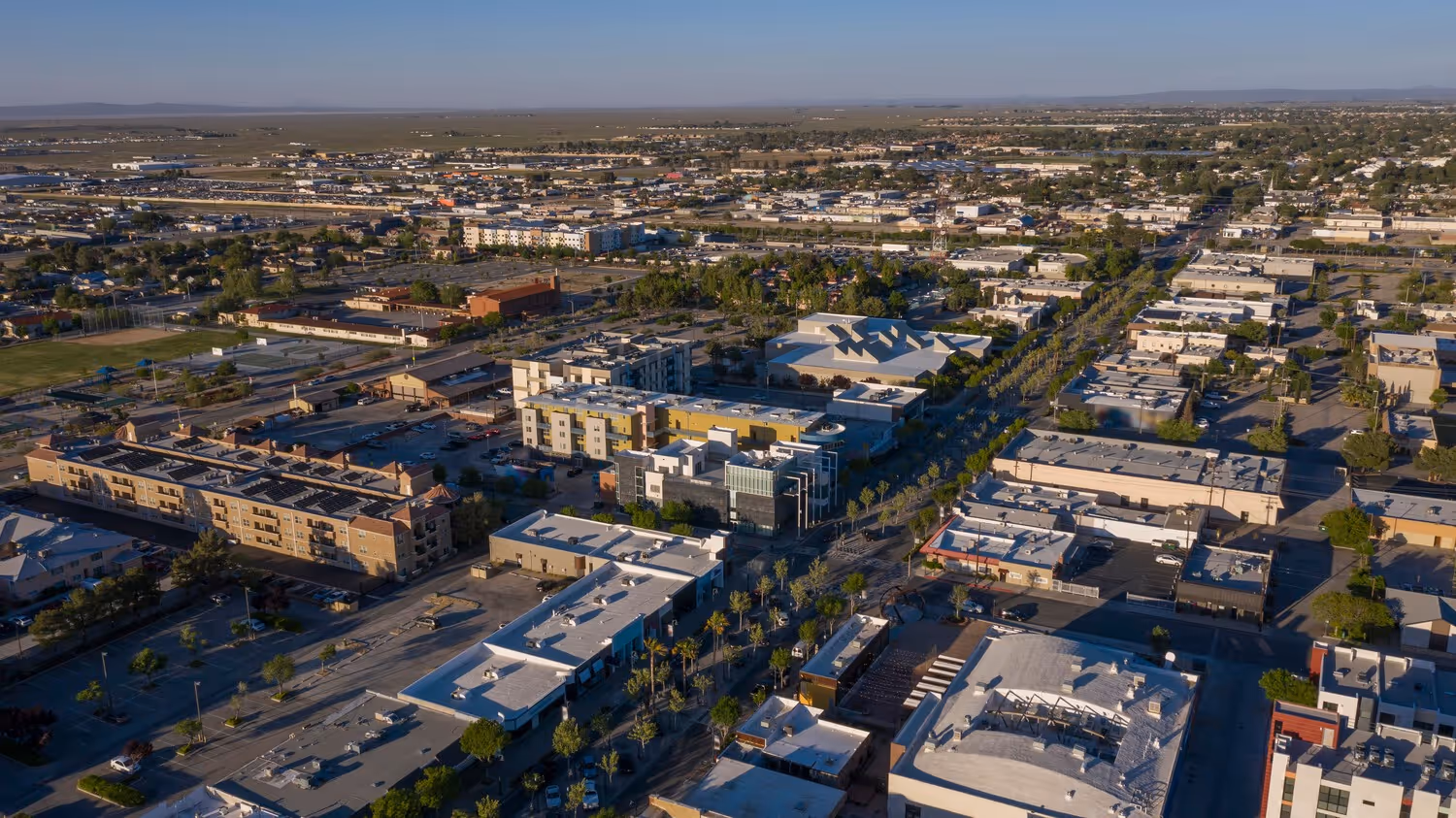 Aerial view of downtown San Diego, California, showcasing skyscrapers, waterfront, and urban layout under clear skies.