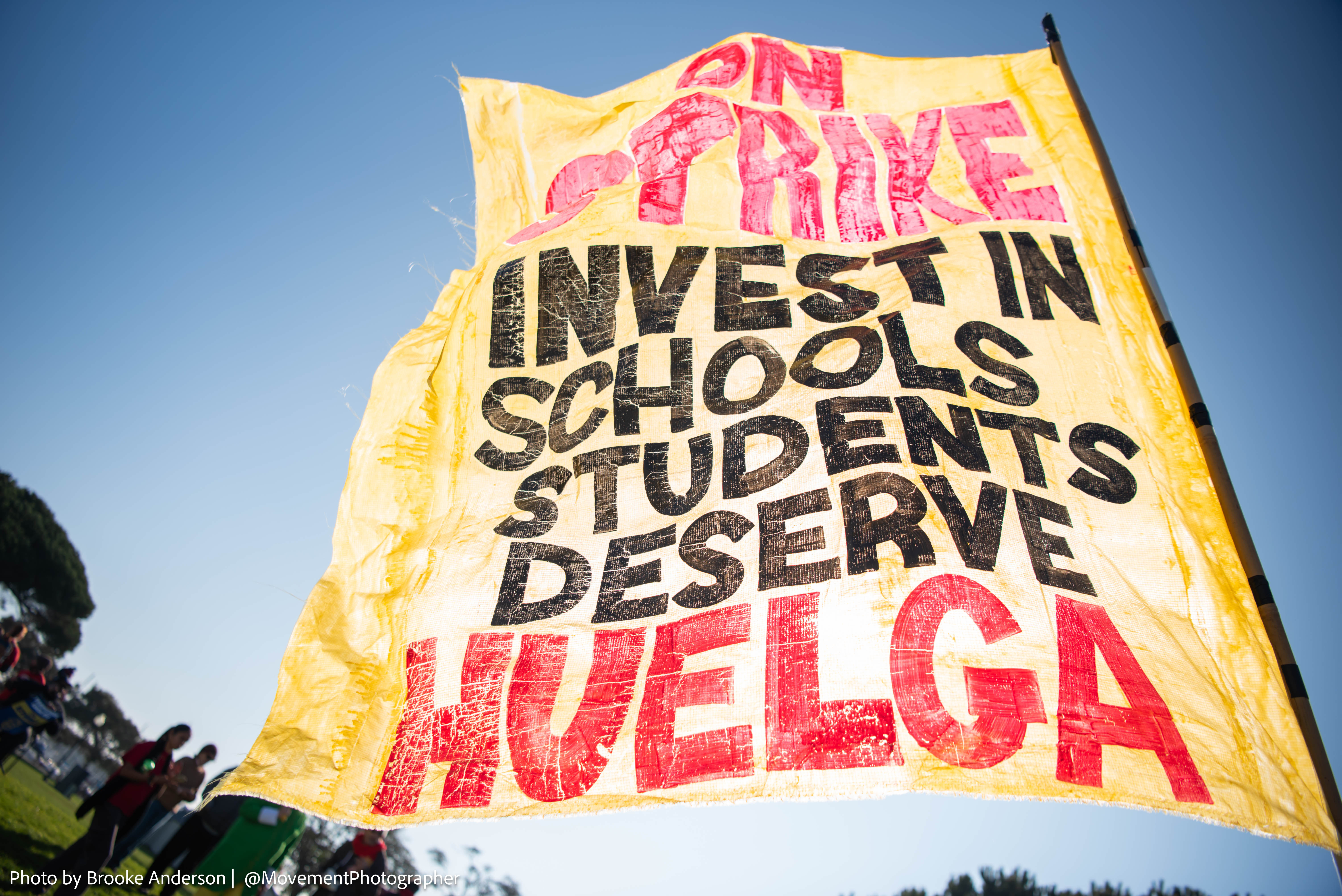 Two women in professional attire, illustrating the concept of following fashion trends for 2025.