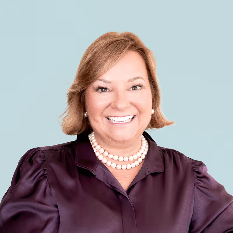 Portrait of Suzan McDaniel against a light background.