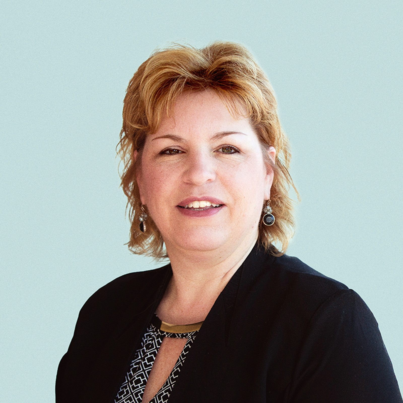 Portrait of Stacey Urry against a light background.