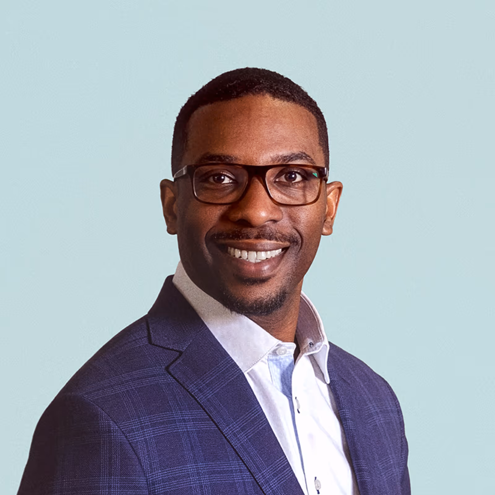 Portrait of D Crum against a light background.