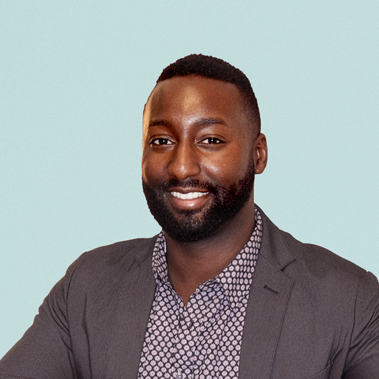 Portrait of Aarsenio Perry against a light background.
