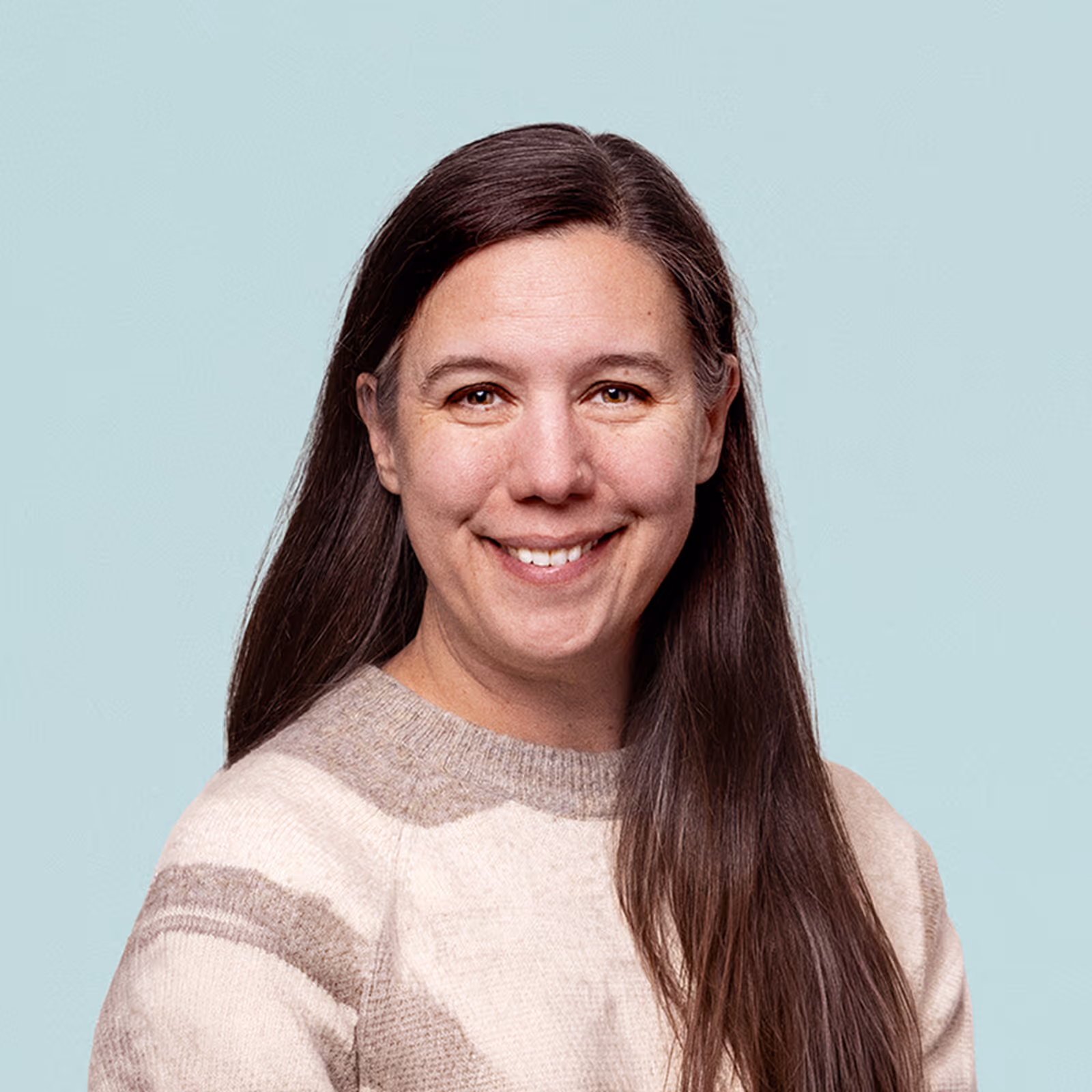 Portrait of Katie Monfre against a light background.