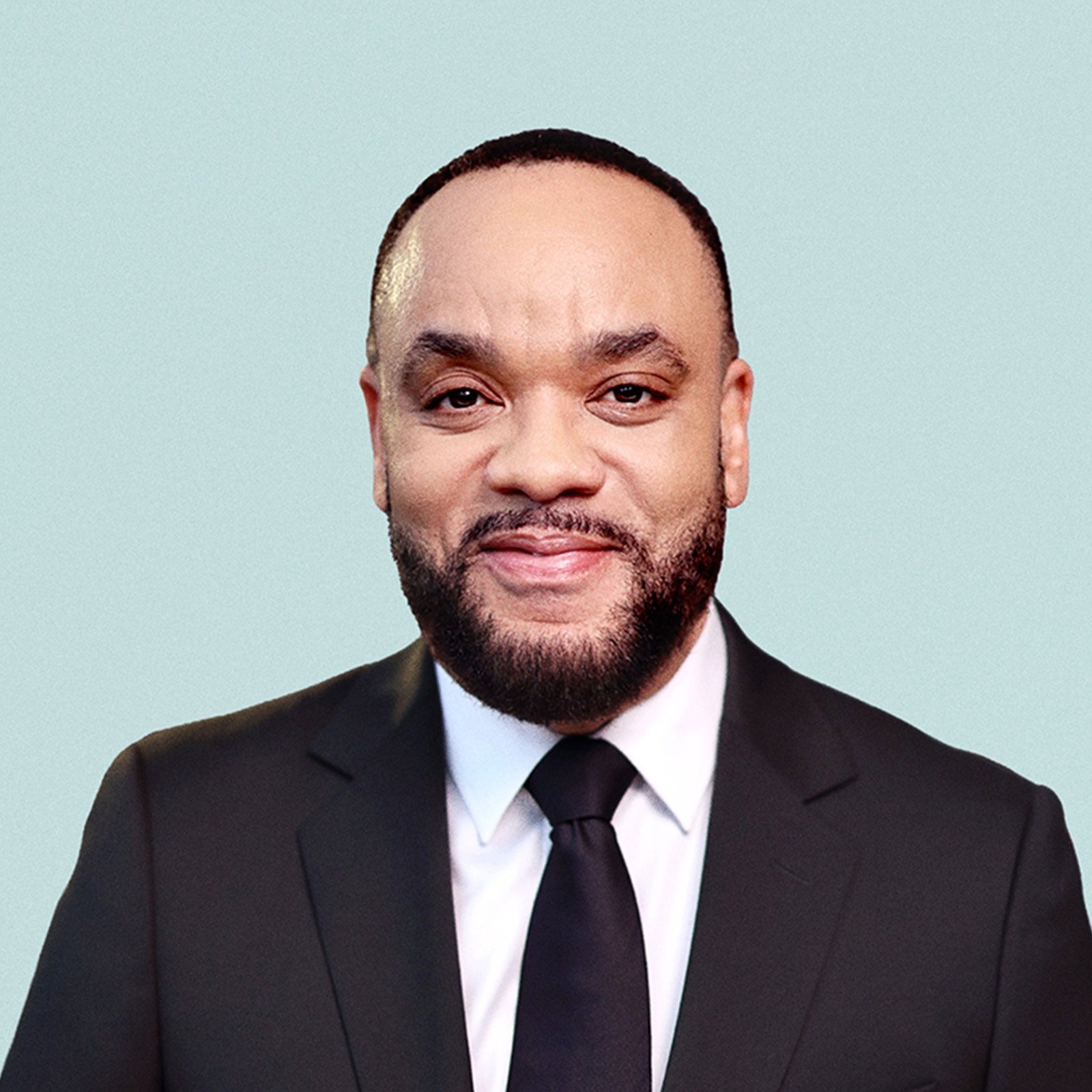 Portrait of Brian Tippens against a light background.