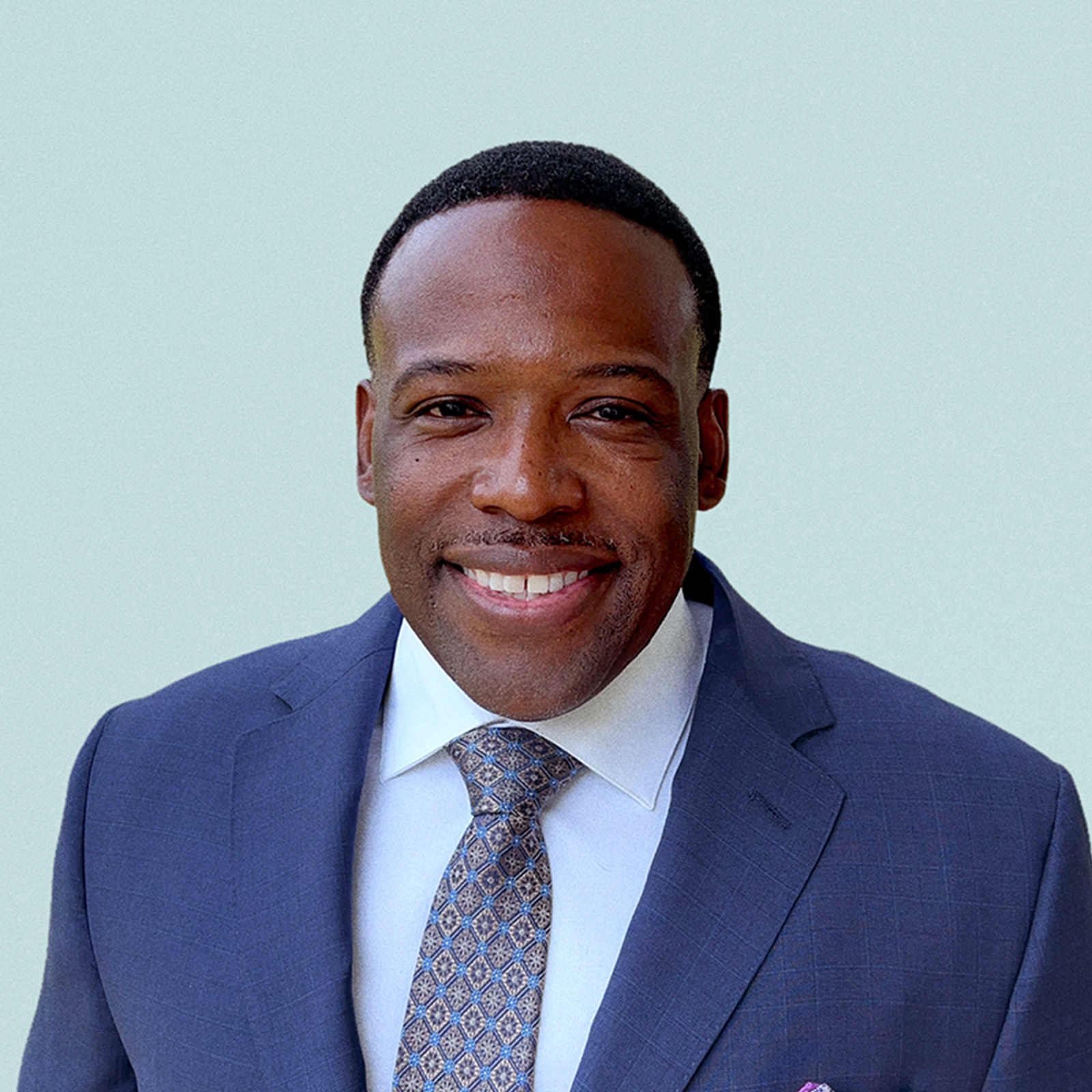 Portrait of Lance Taylor against a light background.
