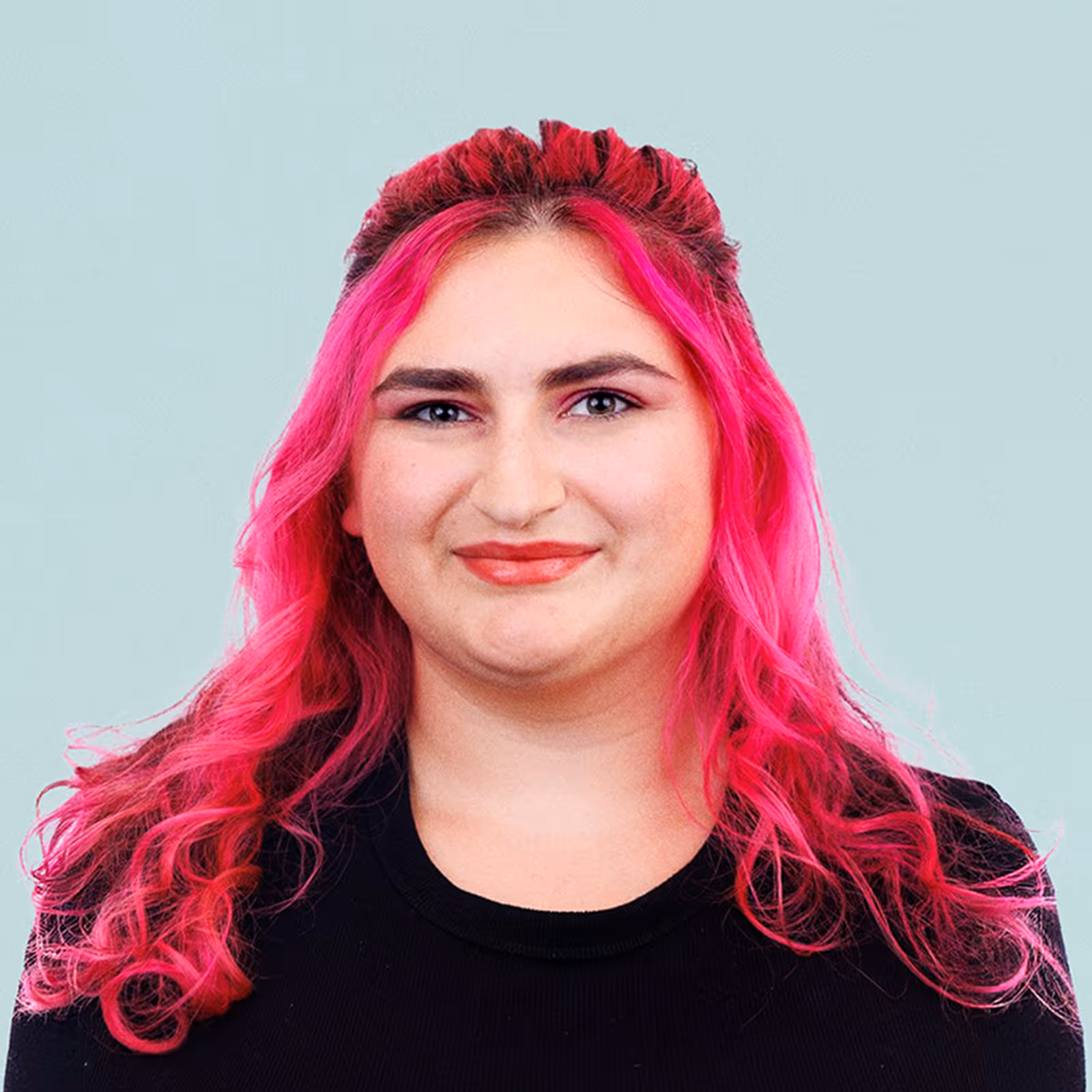 Portrait of Suzan McDaniel against a light background.