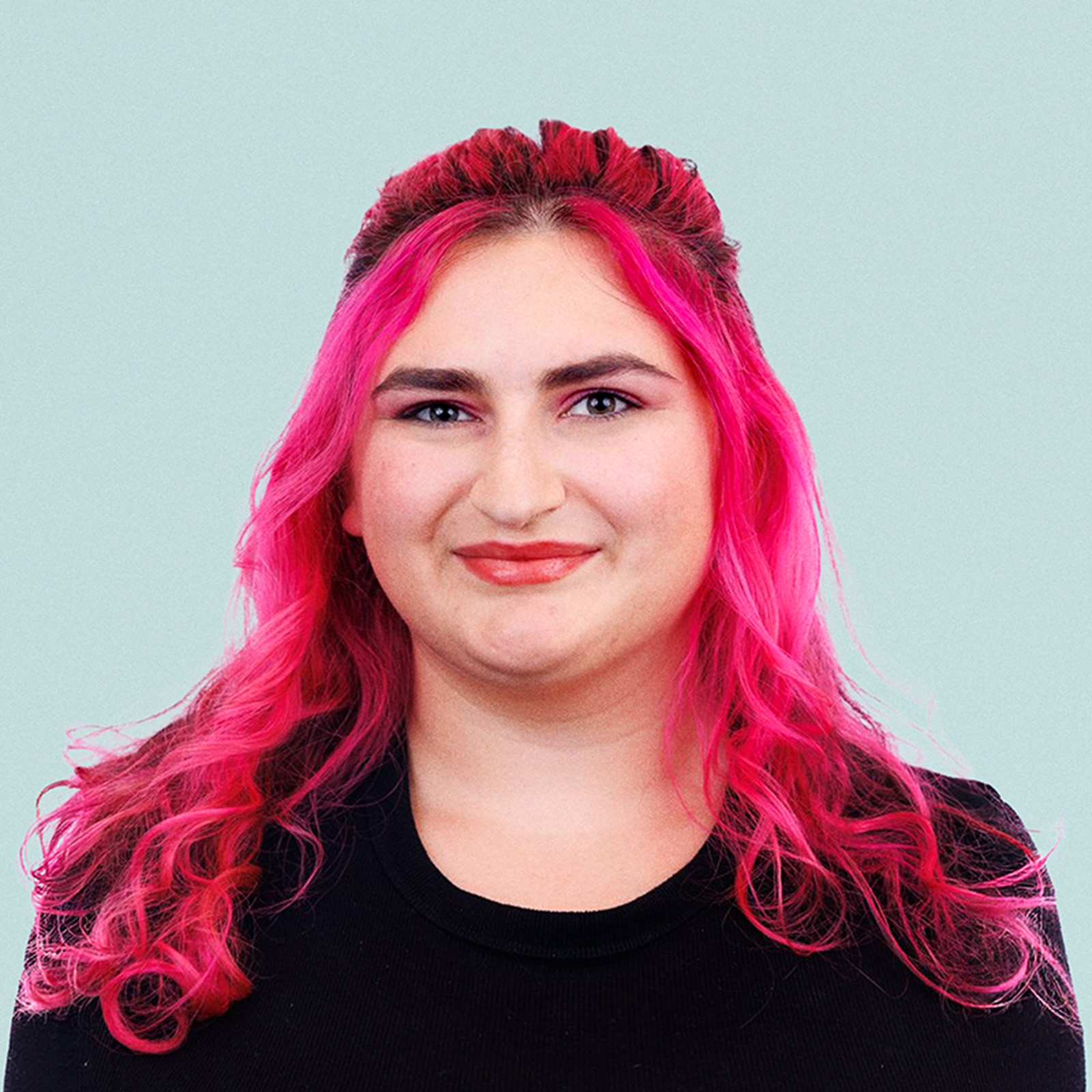 Portrait of Suzan McDaniel against a light background.