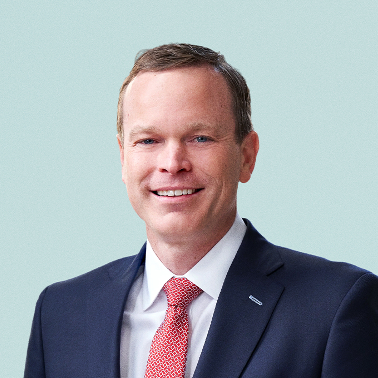 Portrait of Doug Dollenberg against a light background.