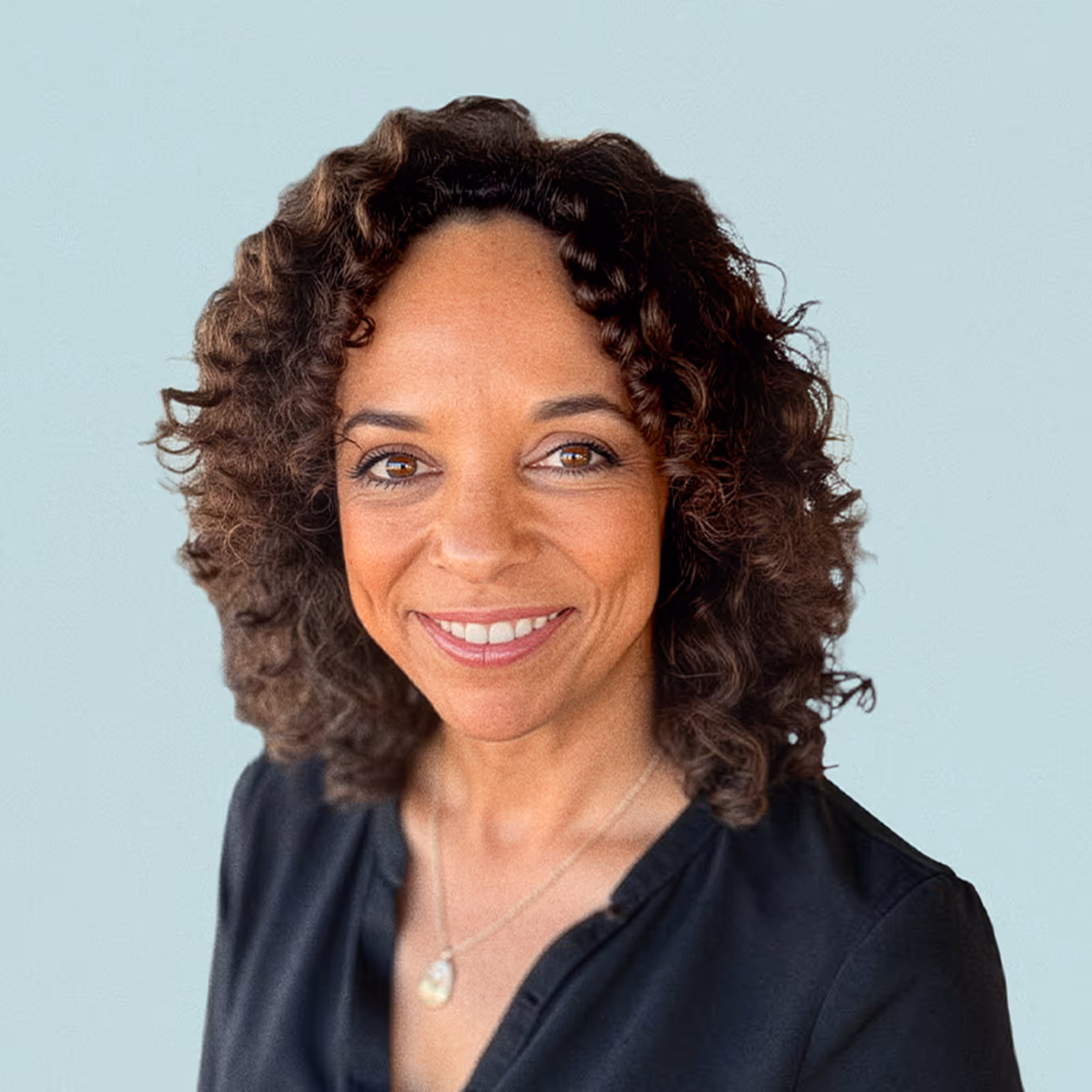 Portrait of Ellen McGrit against a light background.