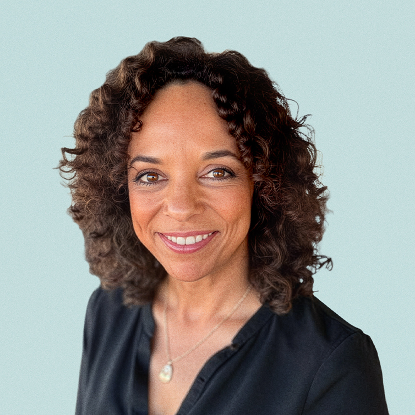 Portrait of Ellen McGrit against a light background.