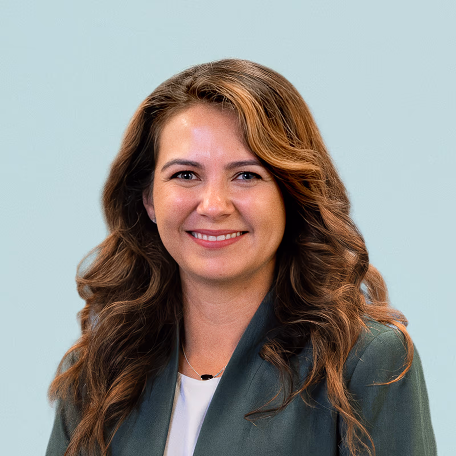 Portrait of Mayra Cardenas against a light background.