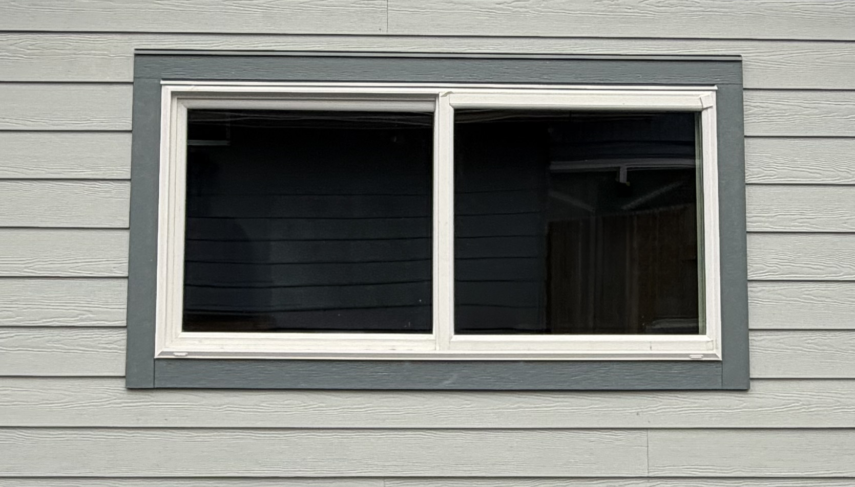 Prime Vinyl Window with Hardie trims exterior