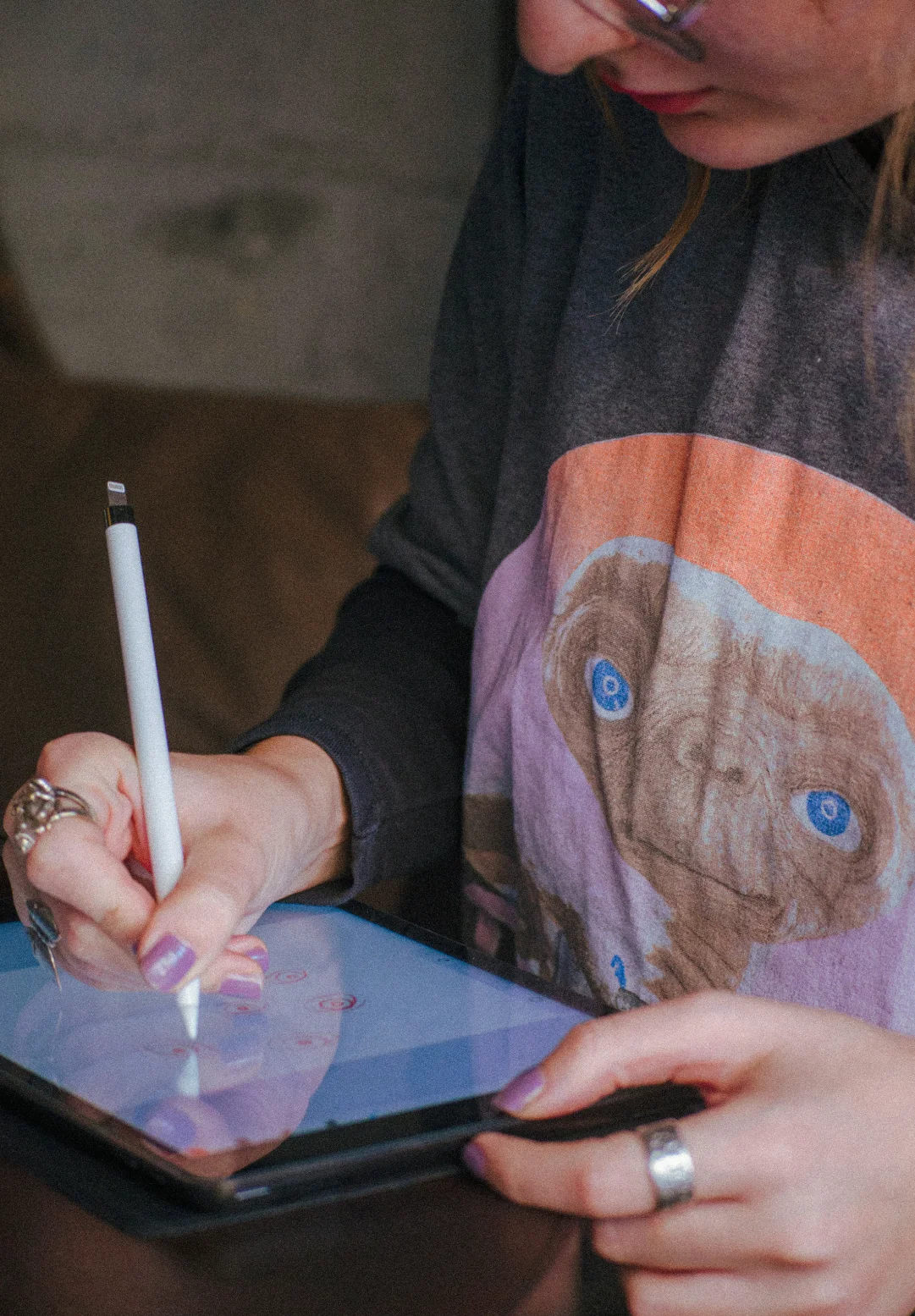 Designer sketching brand concepts on a tablet, representing the creative process behind hospitality and destination brand identity design.