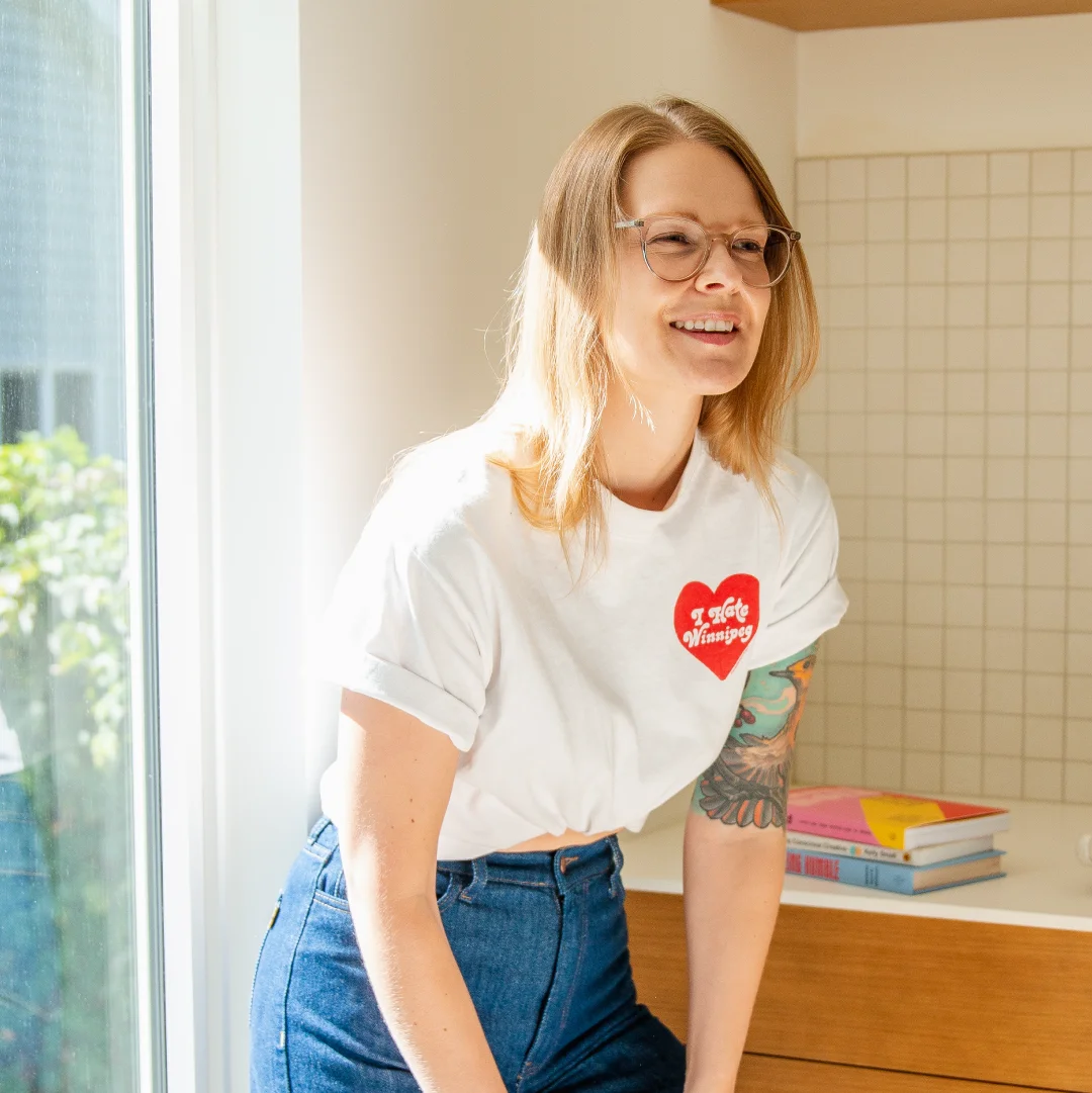 Portrait of a creative founder in a bright studio space, reflecting the personality and leadership behind a hospitality-focused branding studio.
