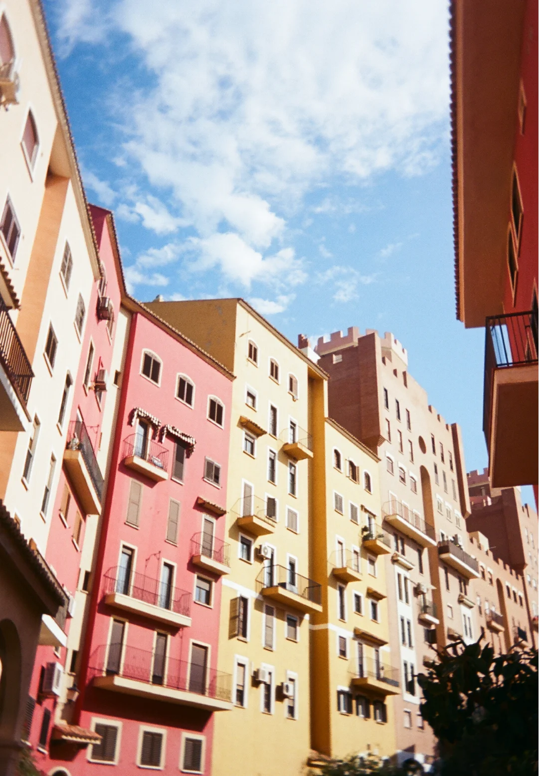 Colourful Mediterranean-style buildings under a bright blue sky, capturing the atmosphere and character of a memorable travel destination.