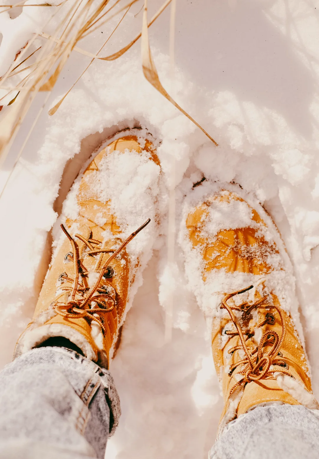 Pair of winter boots covered in fresh snow, evoking the sensory details and lived experience that inspire memorable brand language.