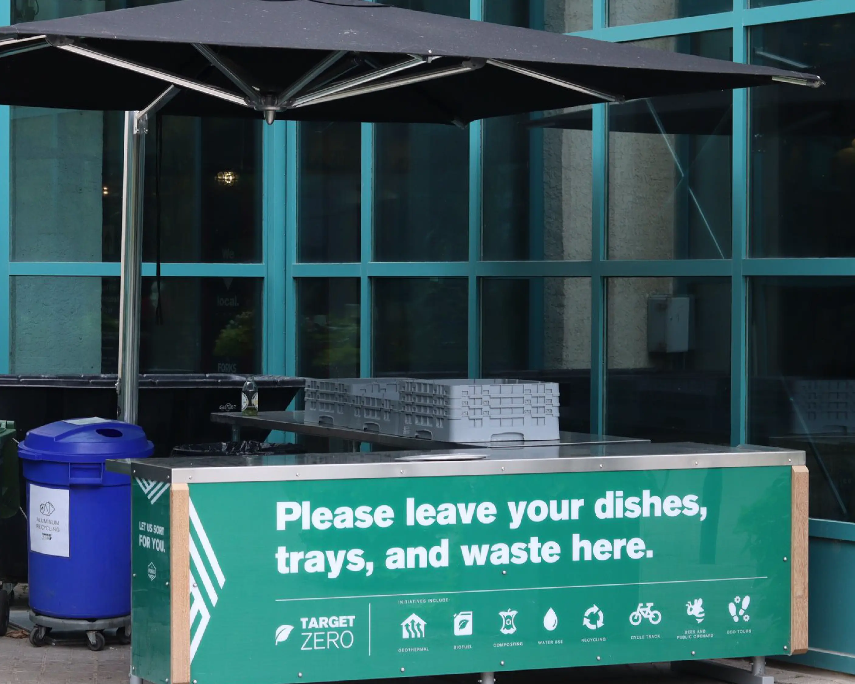 Outdoor Target Zero waste-sorting station at The Forks, with green signage promoting sustainability and environmental initiatives.