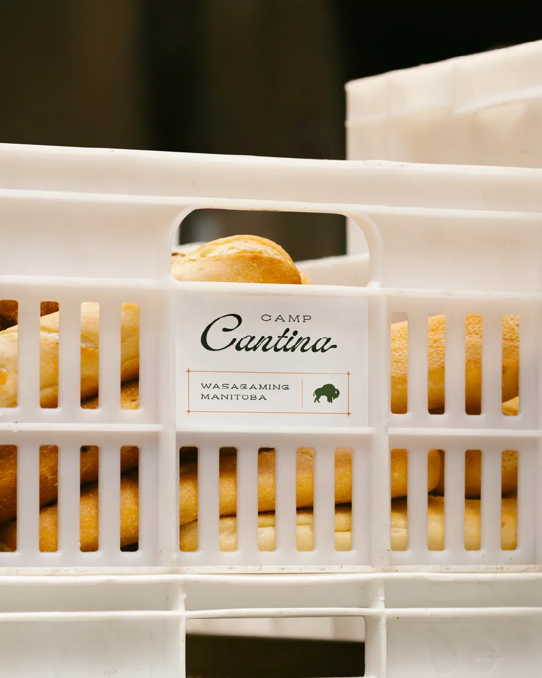 Camp Cantina deli label on a bread crate reading “Wasagaming, Manitoba,” with a bison icon.