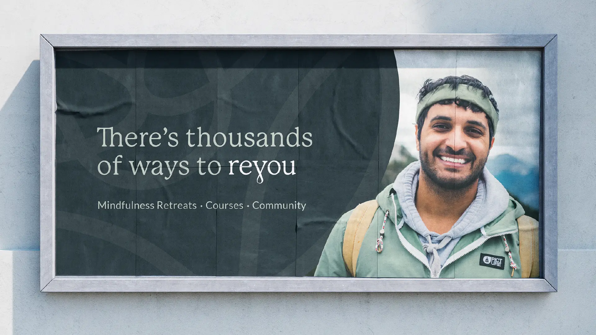 Billboard mockup reading “There’s thousands of ways to reyou” with “Mindfulness Retreats · Courses · Community,” beside a smiling hiker.