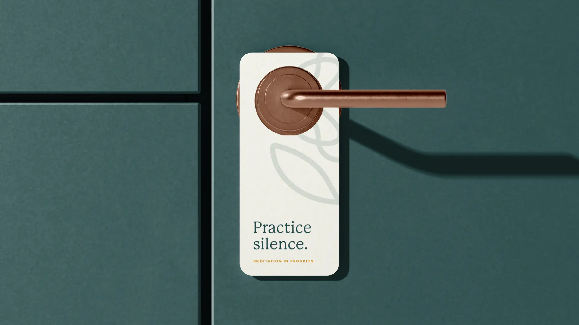 Door hanger sign reading “Practice silence.” and “Meditation in progress.” with subtle Reyou pattern on a teal wall and copper handle.