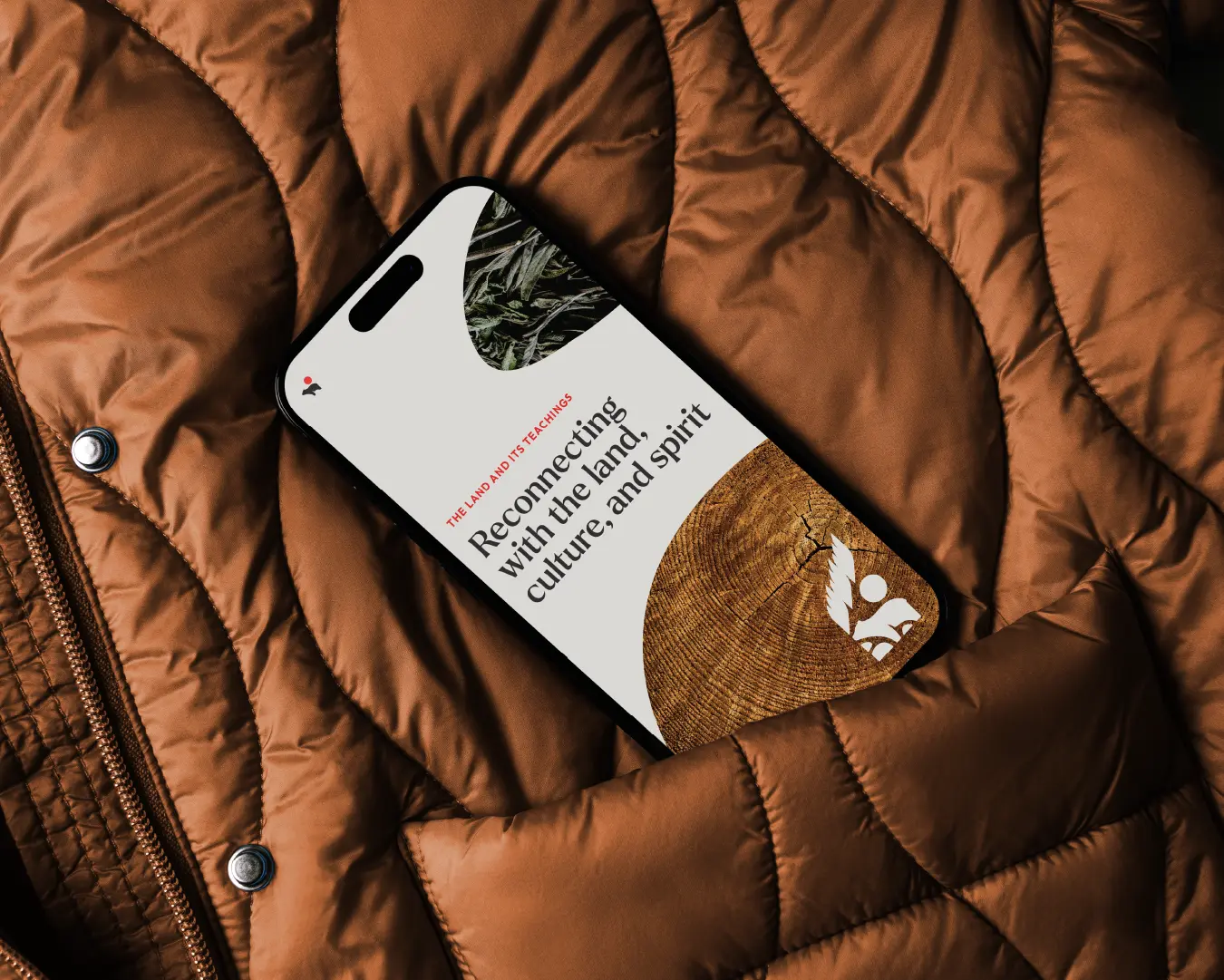 Phone case design featuring “Reconnecting with the land, culture, and spirit” with a wood-grain graphic and logo.