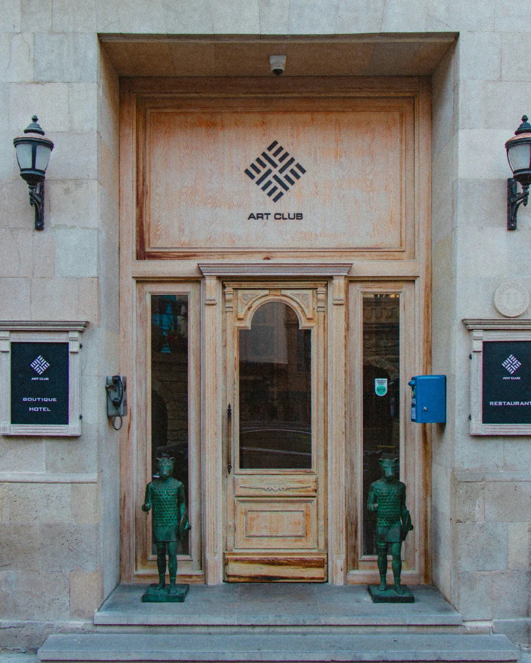 Entrance to Art Club boutique hotel and restaurant, showing branded signage as part of the guest arrival experience.