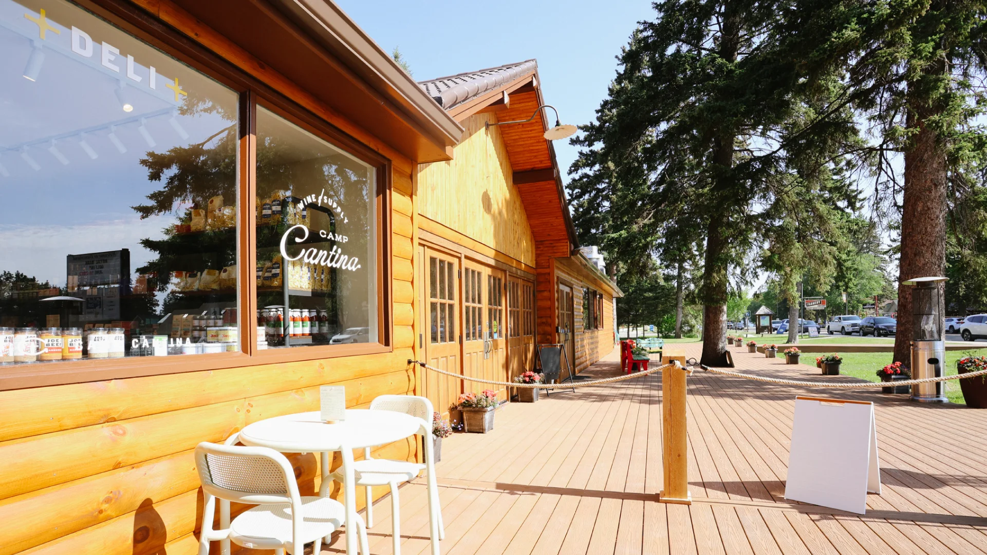 Exterior of Camp Cantina with warm wood siding, window branding, patio seating, and signage showing how restaurant branding extends across the guest experience.
