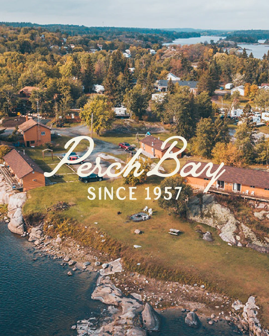 Aerial view of Perch Bay Resort’s waterfront cabins and rocky shoreline in Northern Ontario, with the Perch Bay Since 1957 logo.
