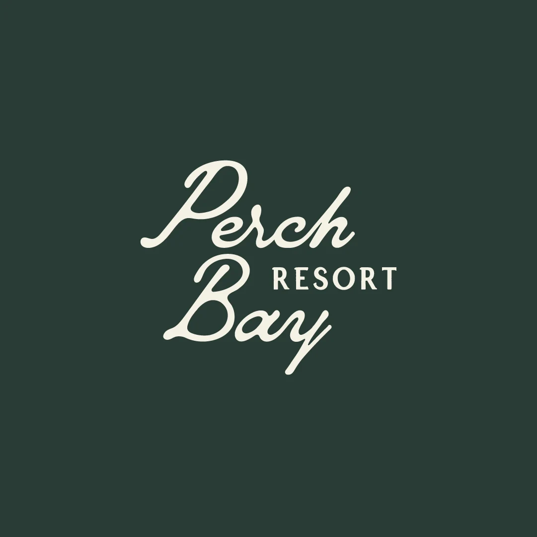 Cream Perch Bay Resort script logo centred on a deep green background.