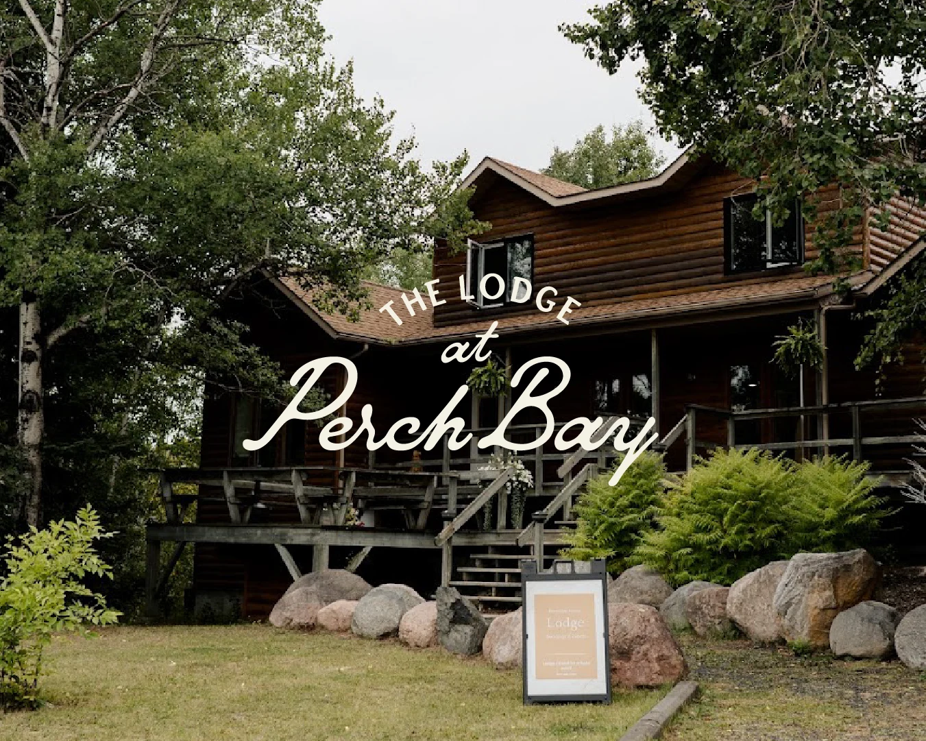 Exterior of The Lodge at Perch Bay, a rustic waterfront wedding and events venue near Kenora, Ontario, with the venue logo overlaid.